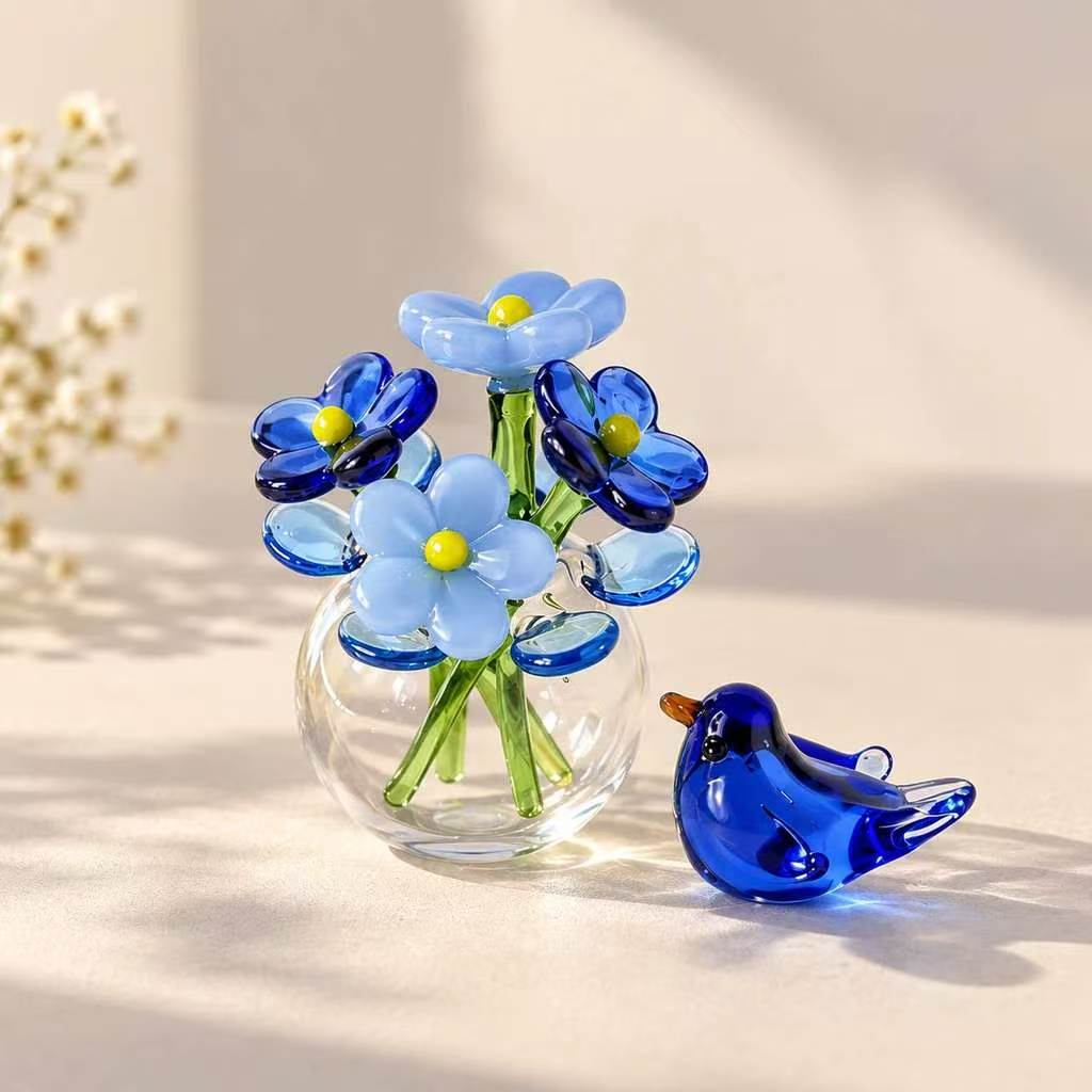 Miniature glass flowers in a small vase